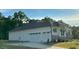 White house with three car garage and landscaping at 1 Kelsey Ct, Hillsborough, NC 27278