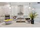 Modern kitchen with white cabinets, quartz countertops and a gold faucet at 1 Kelsey Ct, Hillsborough, NC 27278