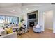 Modern living room with a cozy fireplace and hardwood floors at 1 Kelsey Ct, Hillsborough, NC 27278