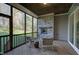 Relaxing screened porch with stone fireplace and wooded views at 1 Kelsey Ct, Hillsborough, NC 27278