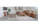 Spacious living room with brown sectional sofa and wood accents at 111 Reagan Crest Dr, Clayton, NC 27520