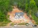 An aerial view shows a new build with brick, surrounded by green forest at 1117 Delilia Ln, Wake Forest, NC 27587