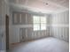 A light-filled bedroom featuring a large window at 1117 Delilia Ln, Wake Forest, NC 27587