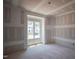 Bright bedroom featuring a large window and ample natural light at 1117 Delilia Ln, Wake Forest, NC 27587