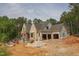 View of a house under construction with garage framing and brick facade at 1117 Delilia Ln, Wake Forest, NC 27587