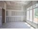 Bright living room with fresh drywall and large windows allowing natural light, ready for customization and personalized touches at 1117 Delilia Ln, Wake Forest, NC 27587