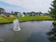 Aerial view of a pond with fountain in a scenic residential community at 1117 Delilia Ln, Wake Forest, NC 27587