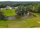 Beautiful aerial view of pond and fountain, surrounded by trees and green fields at 1117 Delilia Ln, Wake Forest, NC 27587