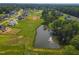 An aerial image shows a fountain in a pond in a lovely residential community at 1117 Delilia Ln, Wake Forest, NC 27587