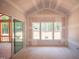 Sunroom with sliding glass doors, drywalled walls, and backyard views offering a bright, airy space with tranquil natural light at 1117 Delilia Ln, Wake Forest, NC 27587