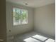 Bedroom featuring a large window offering natural light and views of the outdoors at 132 Black Cloud Dr, Louisburg, NC 27549