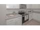 White shaker cabinets, granite counters, and stainless steel appliances at 150 Rolesville Ridge Dr, Rolesville, NC 27571