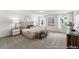 Spacious main bedroom with neutral tones, carpet, large windows and modern furnishings at 300 Nathan Dr # 44P, Lillington, NC 27546