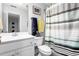 Clean bathroom with shower and striped curtain at 300 Ashwick Dr, Efland, NC 27243