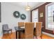 Dining room with dark wood table, woven chairs, and natural light at 300 Ashwick Dr, Efland, NC 27243