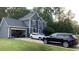 Two-story house, gray siding, red door, attached garage, and driveway at 300 Ashwick Dr, Efland, NC 27243