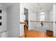 Upstairs hallway with wood floors and a window at 300 Ashwick Dr, Efland, NC 27243