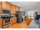 Modern kitchen with stainless steel appliances and wood cabinets at 300 Ashwick Dr, Efland, NC 27243