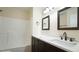 Updated bathroom with dark vanity, quartz countertop, and new lighting at 300 Worth St, Raleigh, NC 27601