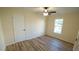 Simple bedroom with hardwood floors, ceiling fan and closet at 300 Worth St, Raleigh, NC 27601