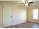 Simple bedroom with hardwood floors, ceiling fan, and a closet at 300 Worth St, Raleigh, NC 27601