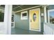 Inviting front porch with a bright yellow door at 300 Worth St, Raleigh, NC 27601
