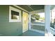 Quaint front porch with white railings and yellow door at 300 Worth St, Raleigh, NC 27601