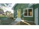 Green house exterior with yellow door and small deck at 300 Worth St, Raleigh, NC 27601