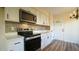 Updated kitchen with stainless steel appliances and white shaker cabinets at 300 Worth St, Raleigh, NC 27601
