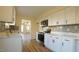 Bright kitchen features white cabinets, stainless steel appliances, and quartz countertops at 300 Worth St, Raleigh, NC 27601