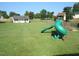 Large grassy backyard featuring a playground at 35 Meadow Ln, Franklinton, NC 27525