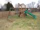 Wooden playset with swings and slide in grassy backyard at 35 Meadow Ln, Franklinton, NC 27525