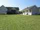 Expansive backyard featuring a lush green lawn and two houses, perfect for outdoor activities and relaxation at 35 Meadow Ln, Franklinton, NC 27525
