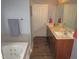 Double vanity bathroom with a jetted tub and wood cabinets at 35 Meadow Ln, Franklinton, NC 27525