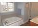 Relaxing bathroom with a large jetted tub and tile surround at 35 Meadow Ln, Franklinton, NC 27525