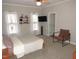 Spacious bedroom with a king-size bed, large windows, and a sitting area at 35 Meadow Ln, Franklinton, NC 27525
