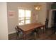 Bright dining area with farmhouse table and chairs, hardwood floors, and view to backyard at 35 Meadow Ln, Franklinton, NC 27525