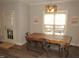 Bright dining area with farmhouse table and chairs, hardwood floors, and view to backyard at 35 Meadow Ln, Franklinton, NC 27525