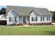 Charming single-story home with a well-manicured lawn, covered porch, and classic architectural details at 35 Meadow Ln, Franklinton, NC 27525