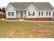 Inviting single-story home with a cozy front porch, a teal front door, and neat landscaping along the foundation at 35 Meadow Ln, Franklinton, NC 27525
