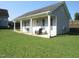 A covered porch with rocking chair is the focus of this home's side exterior at 35 Meadow Ln, Franklinton, NC 27525
