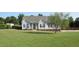 Charming one-story home with a well-manicured lawn, dark shutters, and inviting front porch at 35 Meadow Ln, Franklinton, NC 27525