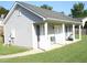 A covered porch with rocking chair is the focus of this home's side exterior at 35 Meadow Ln, Franklinton, NC 27525