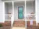 Front porch with rocking chairs and teal front door at 35 Meadow Ln, Franklinton, NC 27525