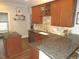 Spacious kitchen with granite countertops, wood cabinets, and an island at 35 Meadow Ln, Franklinton, NC 27525