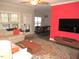 Cozy living room with a large window, a striking red accent wall and modern furnishings at 35 Meadow Ln, Franklinton, NC 27525