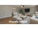 Virtually staged living room with modern furniture, a large TV, and hardwood floors at 35 Meadow Ln, Franklinton, NC 27525