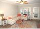 Bright living room featuring a large sectional sofa, ceiling fan, and area rug at 35 Meadow Ln, Franklinton, NC 27525