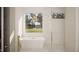 Luxurious bathroom featuring a freestanding tub, sleek fixtures, and a picture window overlooking the lawn at 403 Carolyn Ct, Cary, NC 27511