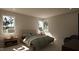 Well-lit bedroom with two large windows, two nightstands, and a comfortable lounge chair at 403 Carolyn Ct, Cary, NC 27511